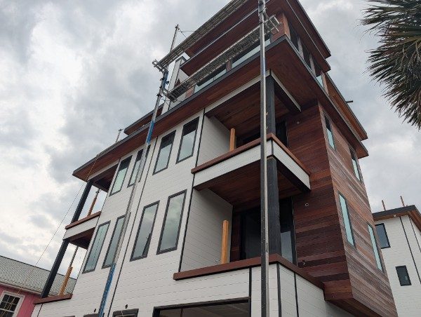 The same coastal build after Cerro Painting exterior coatings — finished siding and wood cladding